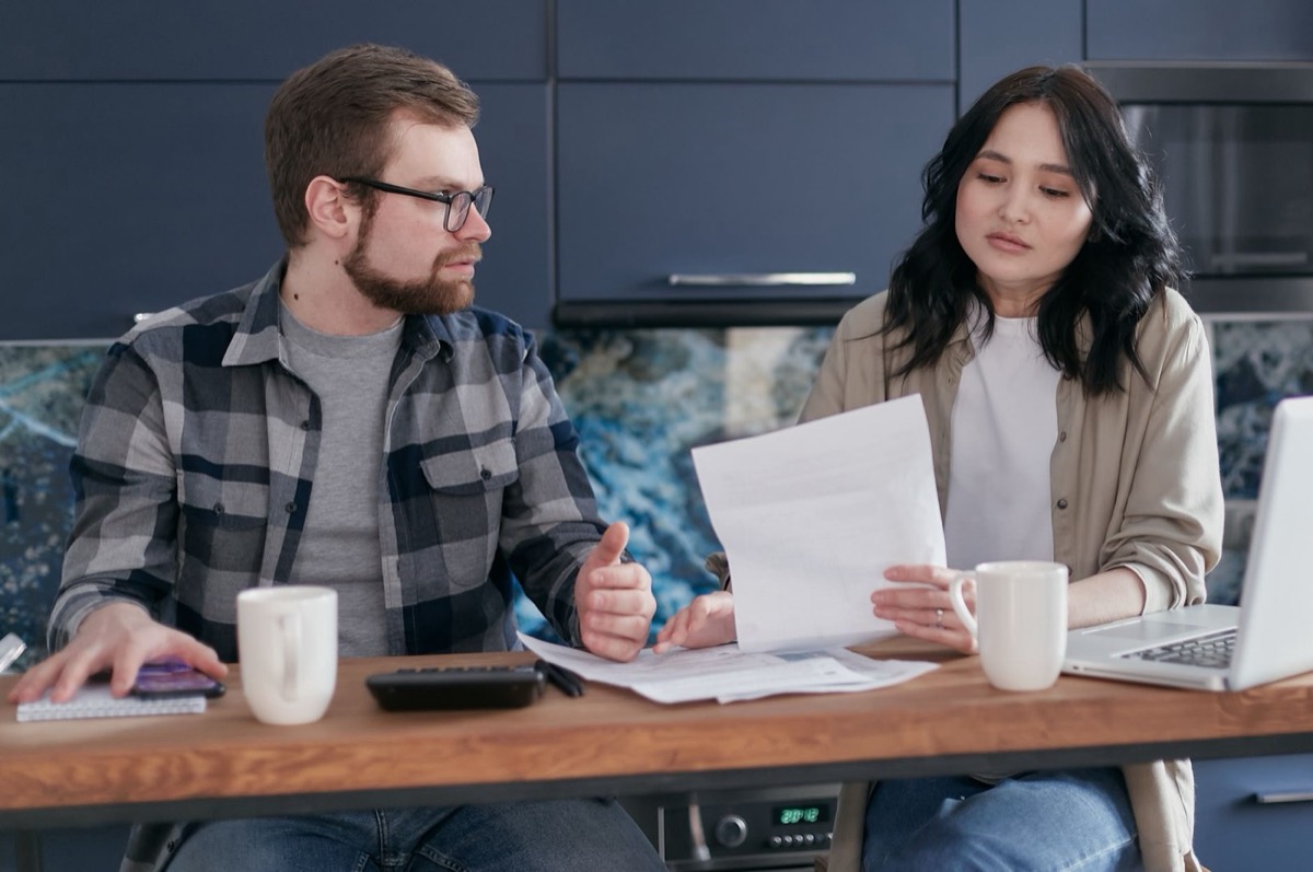 Texas couple reviewing IRS tax debt and payment plan options at the kitchen table before calling a Corpus Christi tax relief attorney