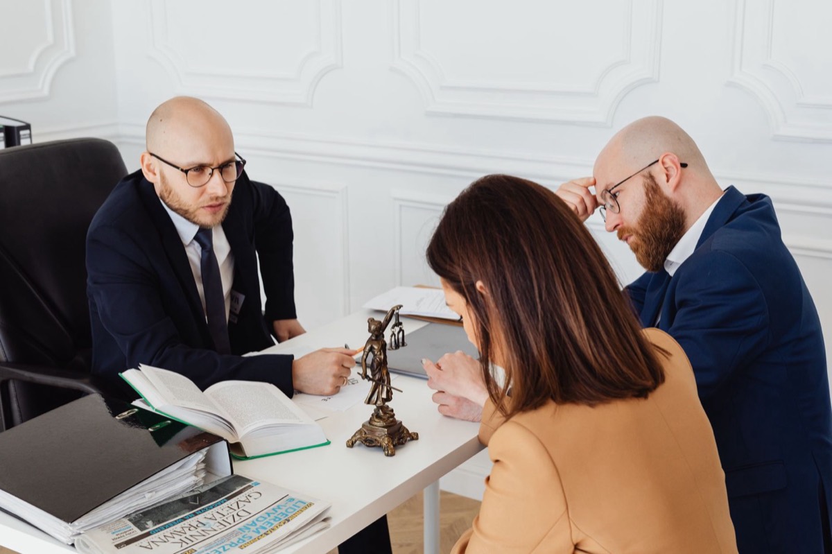 Tax lawyers reviewing an offer in compromise with a Texas client, pennies on the dollar IRS settlement consultation