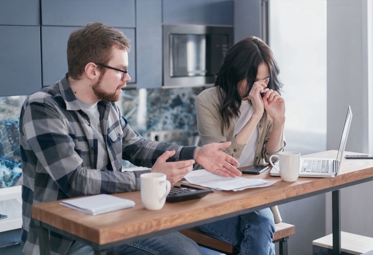 Stressed Texas couple reviewing bills after an IRS bank account levy, getting help within the 21-day levy window
